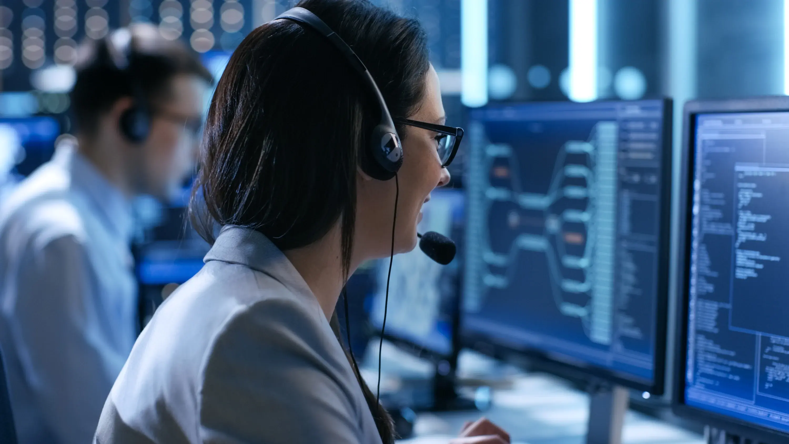 Data support operator with headset speaking to a customer