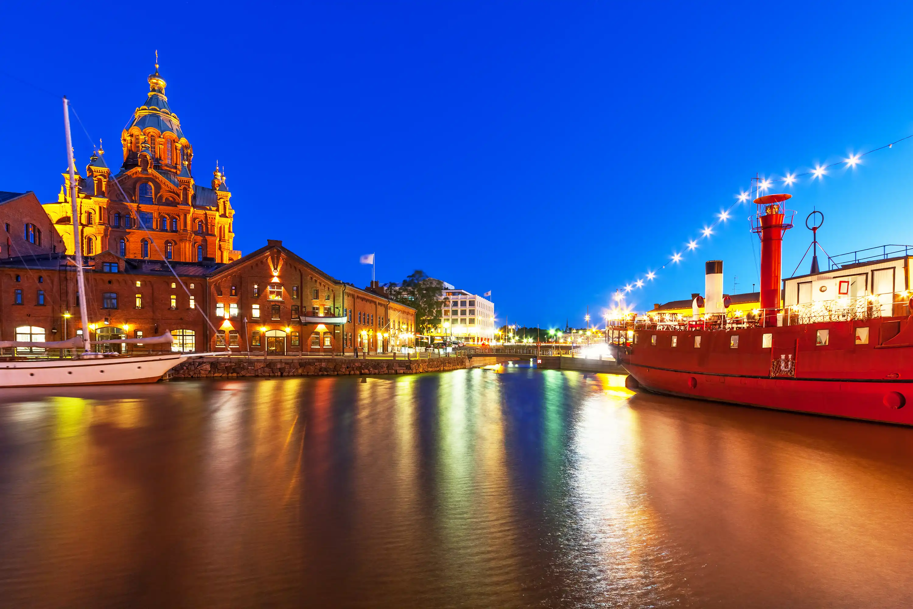 Helsinki Finland, with a boat in light on the water