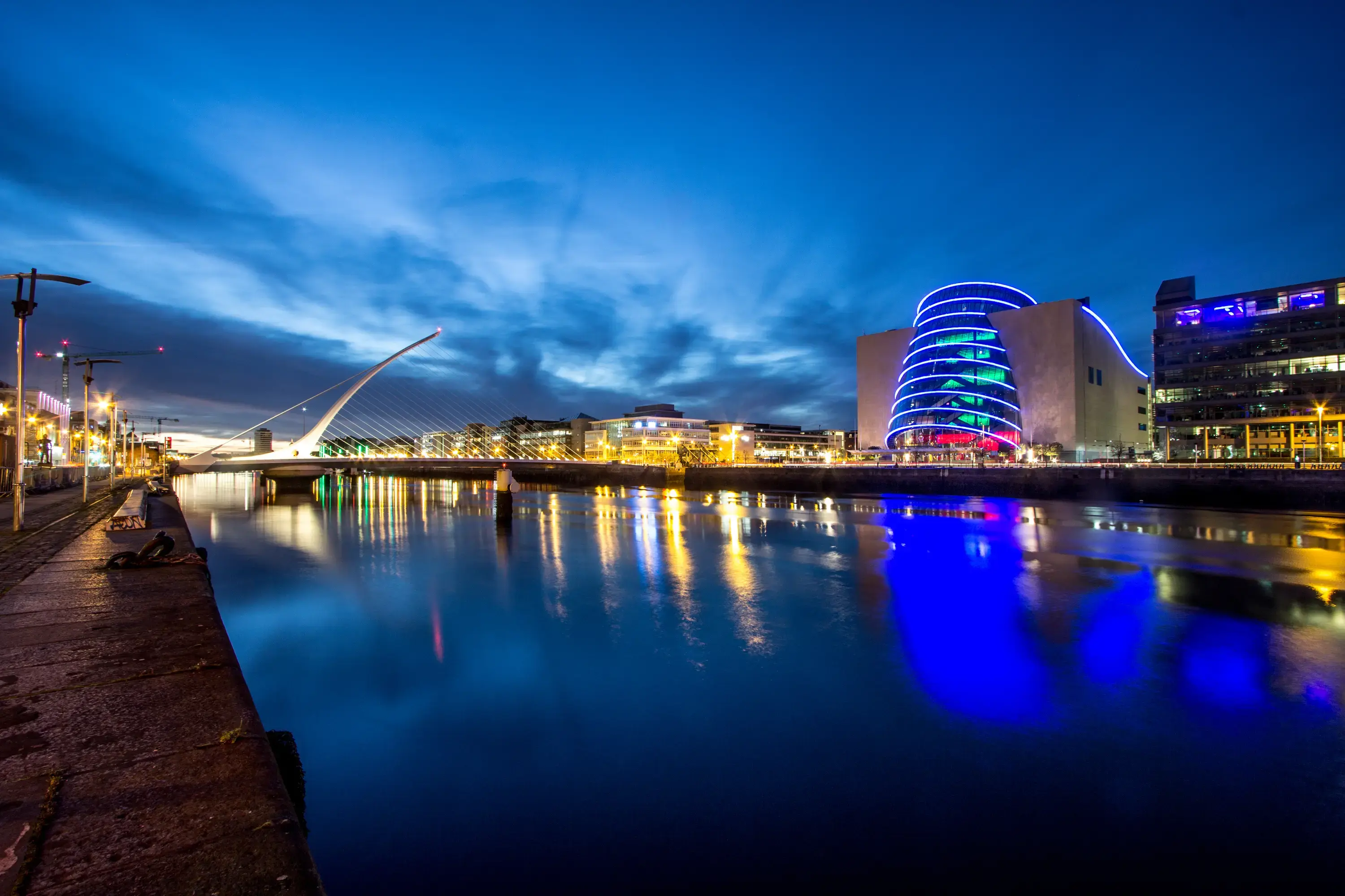 Iconic bridge in Dublin at night across a calm river