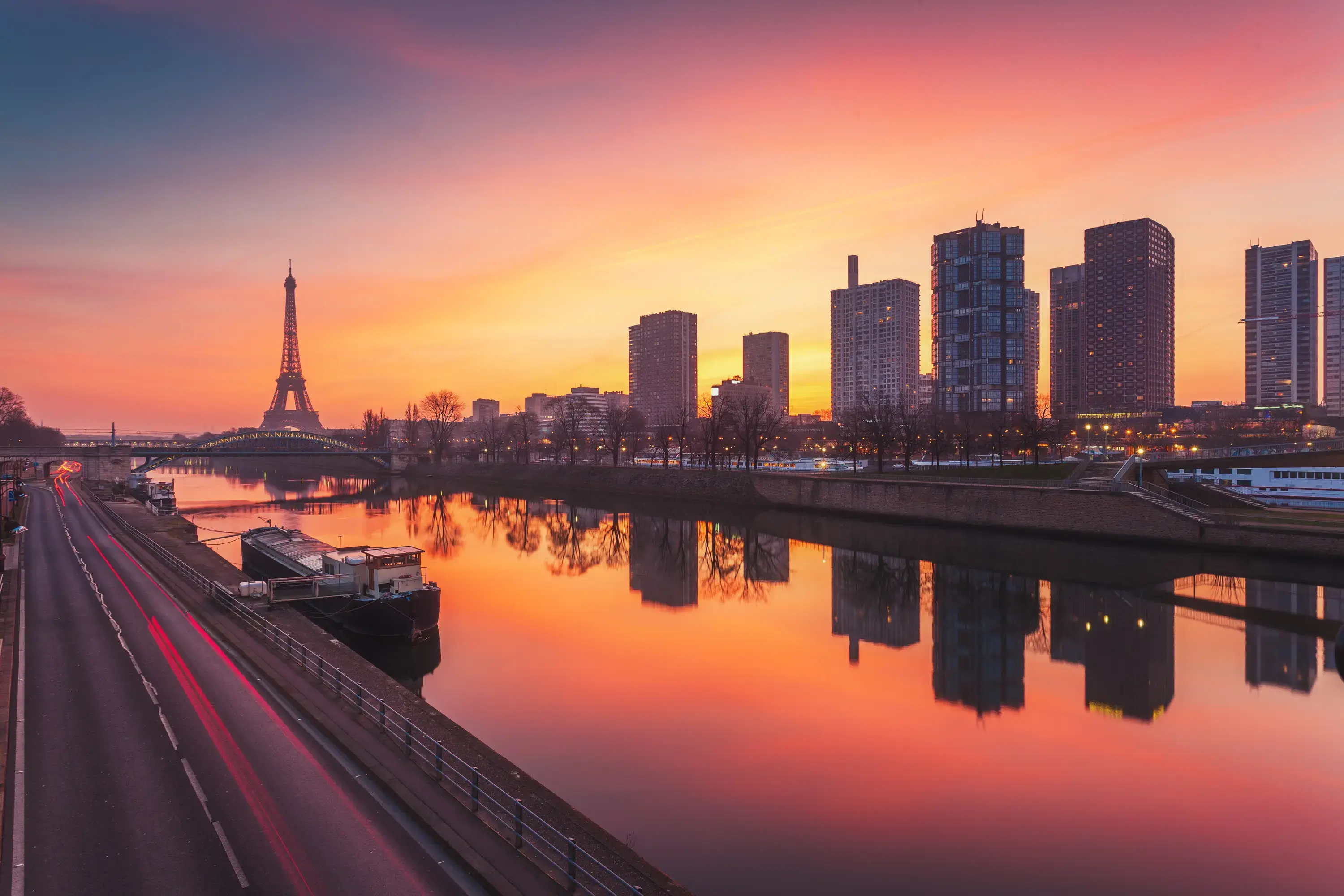Paris, with the Eiffel Tower on the left, the river running in front, and buildings to the right